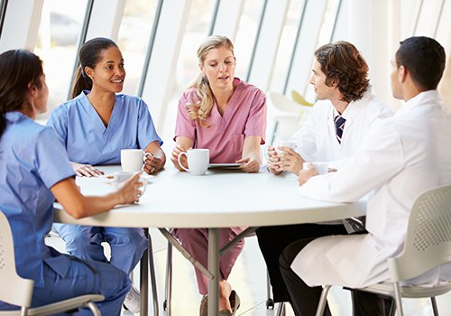 Doctors and nurses at a table